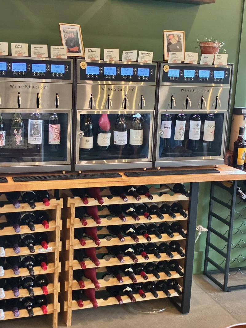 WineStation dispensers and wine racks at a tasting room — the physical infrastructure your digital operations support